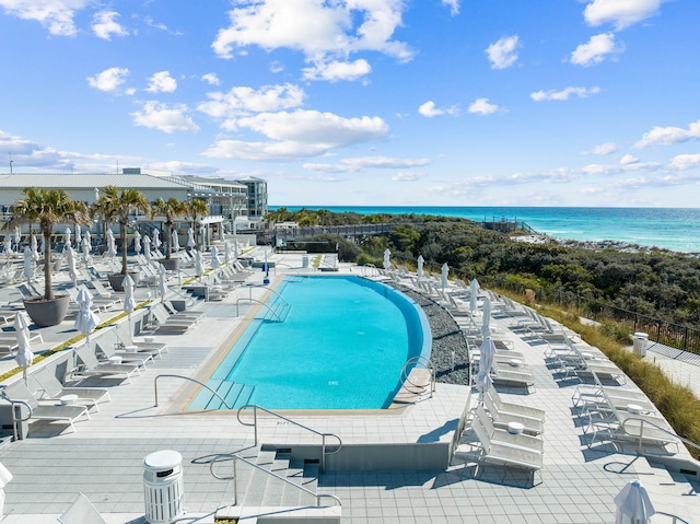 view of swimming pool with a patio and a water view