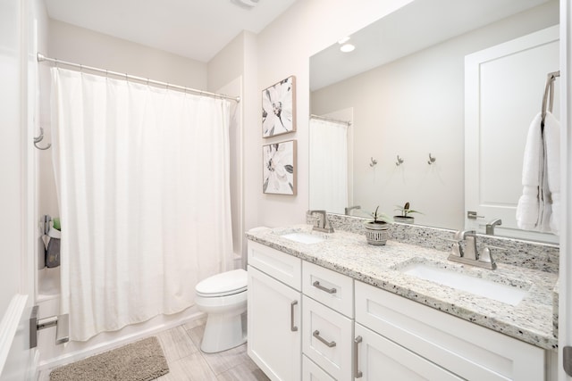 bathroom with double vanity, toilet, shower / bathtub combination with curtain, and a sink