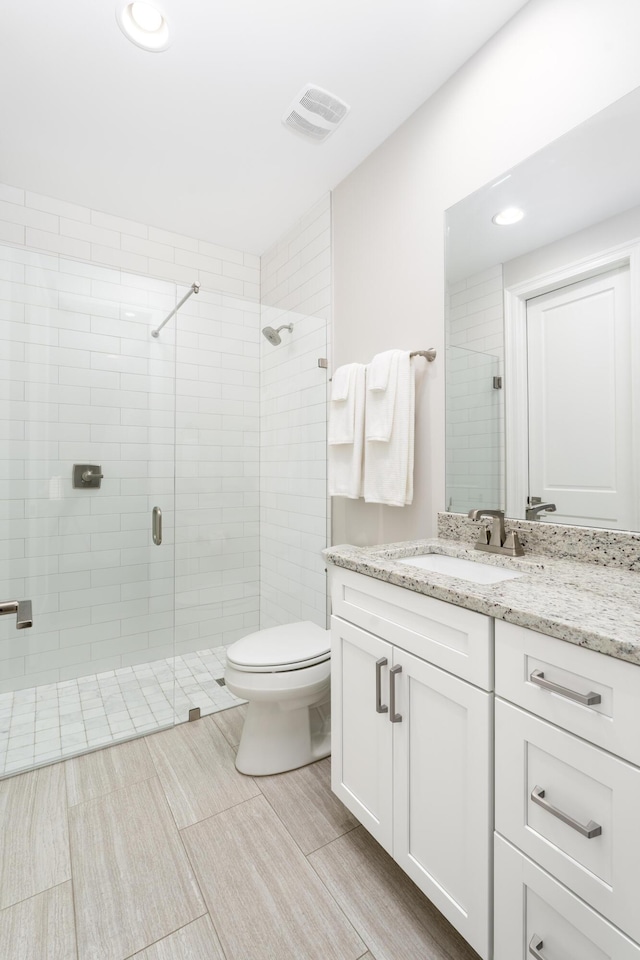 full bathroom featuring vanity, visible vents, recessed lighting, a shower stall, and toilet