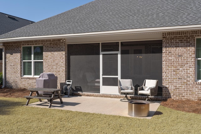 view of patio with a sunroom and a grill