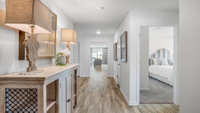 hall with light hardwood / wood-style floors