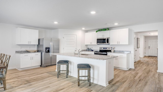 kitchen with white cabinets and appliances with stainless steel finishes