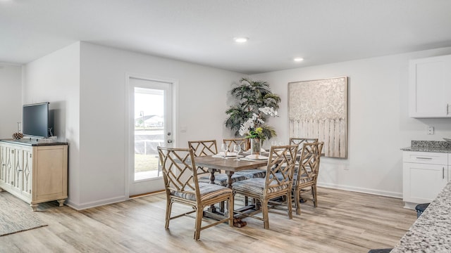 dining space with light wood-type flooring