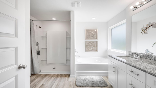 bathroom with vanity, wood-type flooring, and independent shower and bath