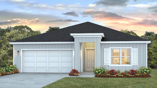 view of front facade with driveway, a shingled roof, a front lawn, a garage, and board and batten siding