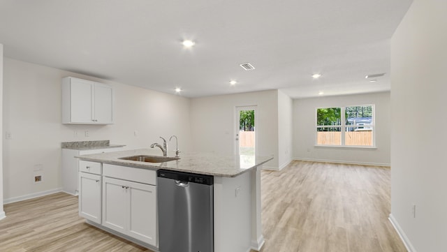 kitchen with a sink, light wood-style floors, white cabinets, and dishwasher