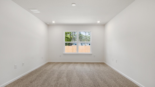carpeted empty room with baseboards