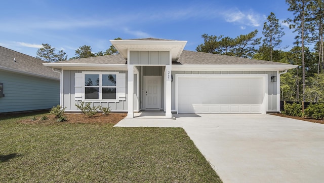 view of front of property featuring concrete driveway, board and batten siding, a shingled roof, and a garage