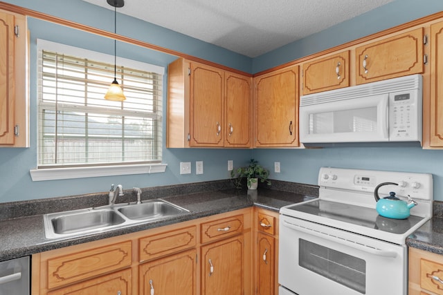 kitchen featuring sink, white appliances, hanging light fixtures, and a textured ceiling