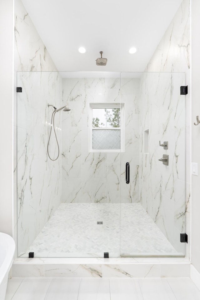 bathroom featuring a shower with shower door