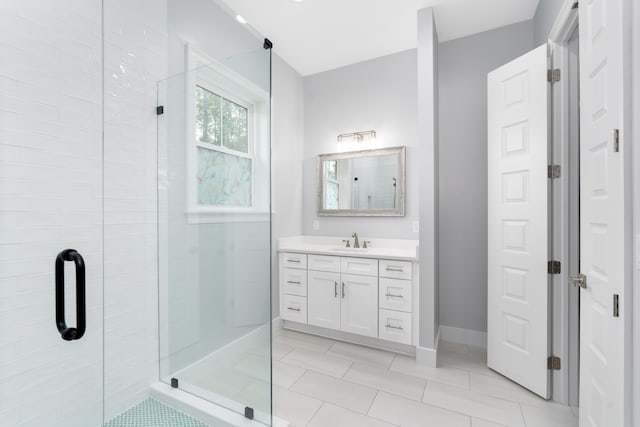 bathroom with tile patterned floors, vanity, and an enclosed shower