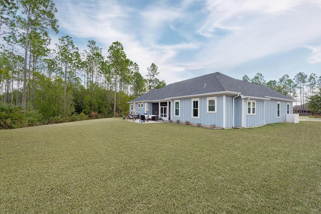 view of front of property with a patio and a front lawn