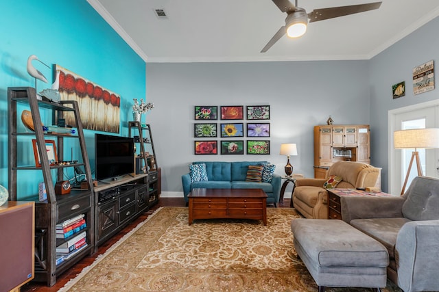 living room featuring hardwood / wood-style flooring, ceiling fan, and crown molding