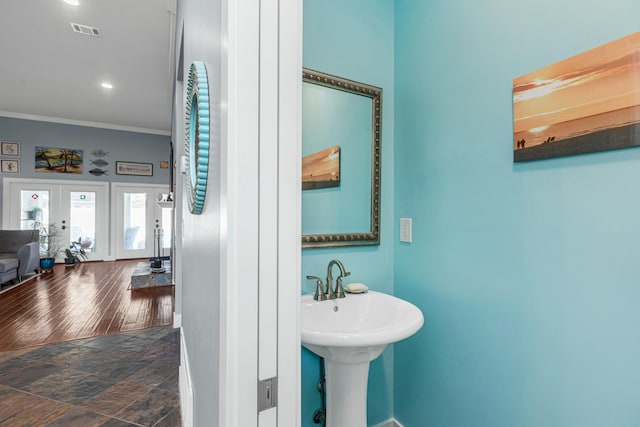 bathroom with sink, crown molding, and french doors