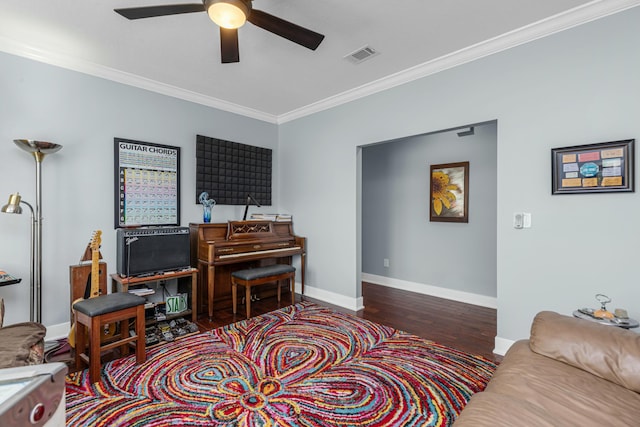 interior space with dark wood-type flooring, ornamental molding, and ceiling fan