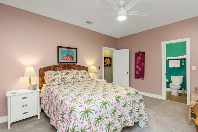 bedroom featuring connected bathroom, light carpet, and ceiling fan