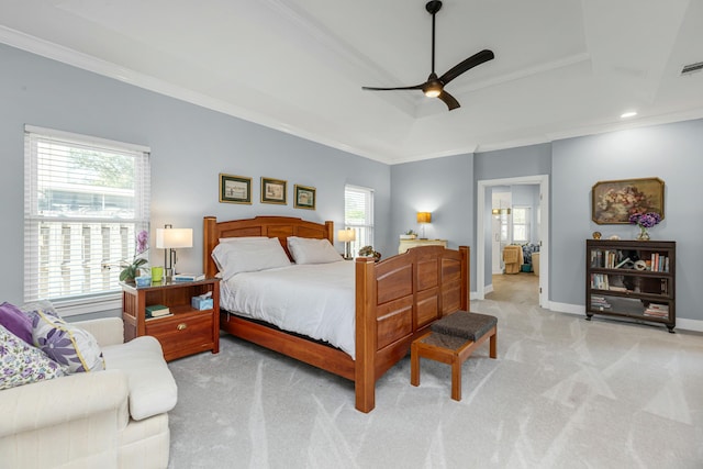 carpeted bedroom featuring ceiling fan, ornamental molding, and a raised ceiling