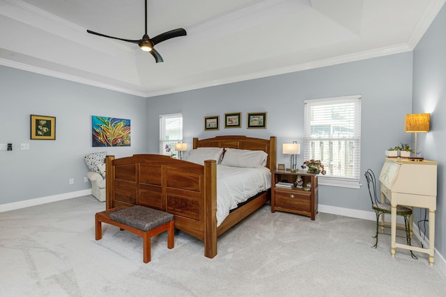 bedroom featuring ceiling fan, light colored carpet, ornamental molding, and a raised ceiling