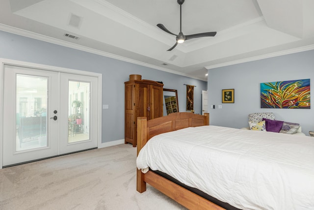 bedroom featuring ornamental molding, light colored carpet, access to exterior, a raised ceiling, and french doors