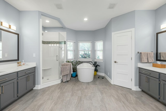 bathroom with vanity and separate shower and tub