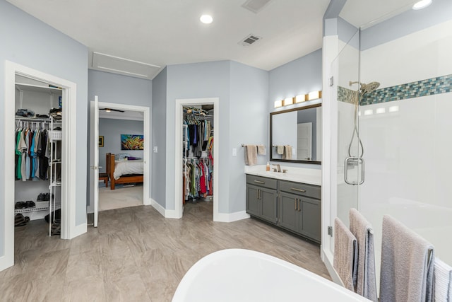 bathroom featuring vanity and independent shower and bath