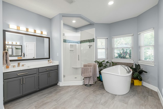 bathroom with independent shower and bath and vanity