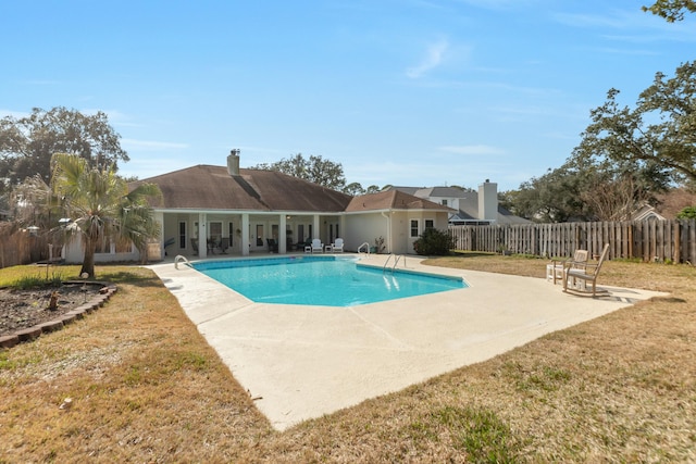 view of swimming pool featuring a patio area and a lawn