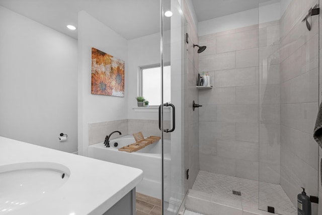 bathroom with a sink, a shower stall, and a bath