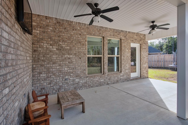 view of patio / terrace with ceiling fan and fence