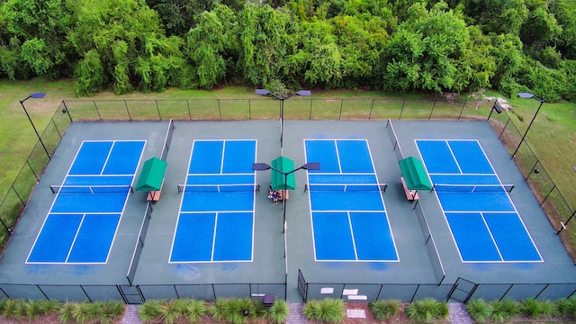 view of tennis court with a lawn