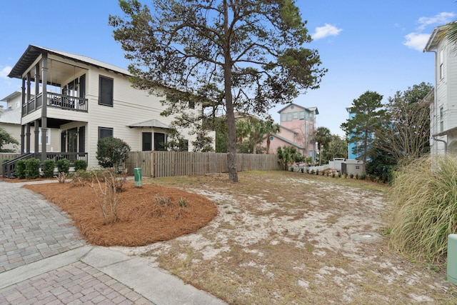 view of yard with a balcony