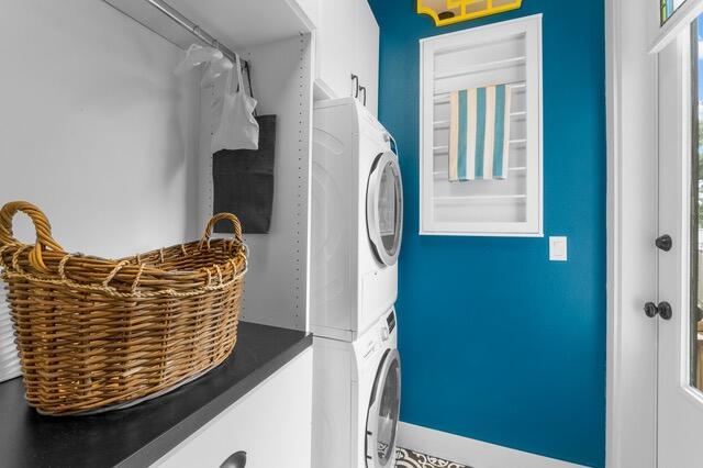 laundry area with stacked washer / dryer