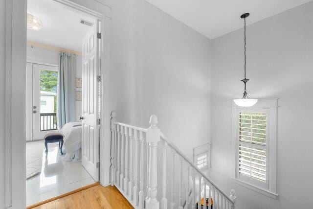 corridor with hardwood / wood-style flooring