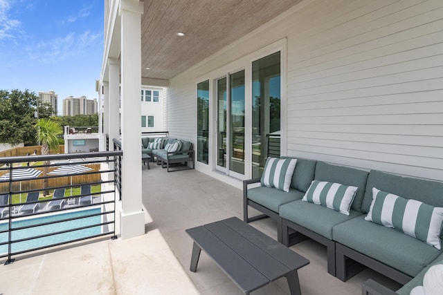 view of patio with an outdoor hangout area and a balcony