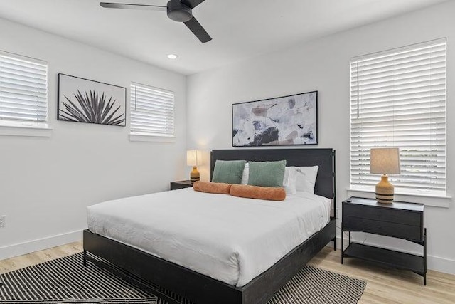 bedroom with ceiling fan and light hardwood / wood-style floors