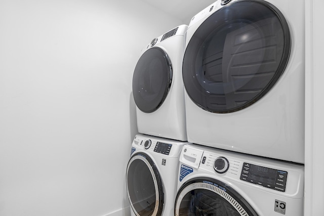 laundry room featuring stacked washer / drying machine