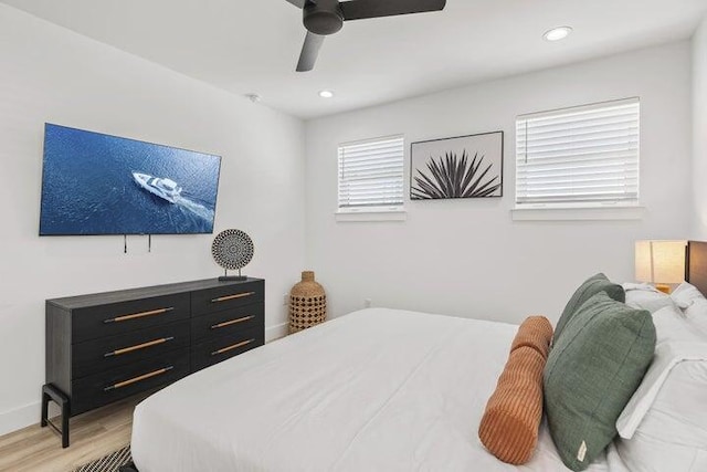 bedroom with ceiling fan and light wood-type flooring