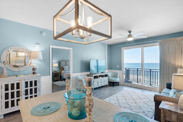 living room featuring ceiling fan with notable chandelier and dark hardwood / wood-style floors