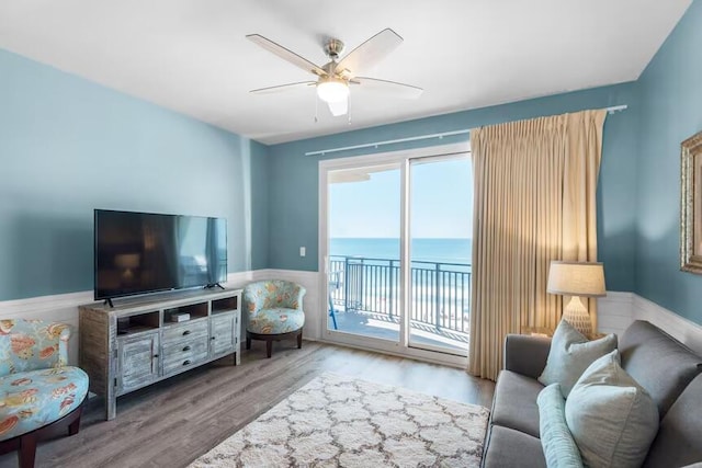 living room featuring light hardwood / wood-style floors and ceiling fan