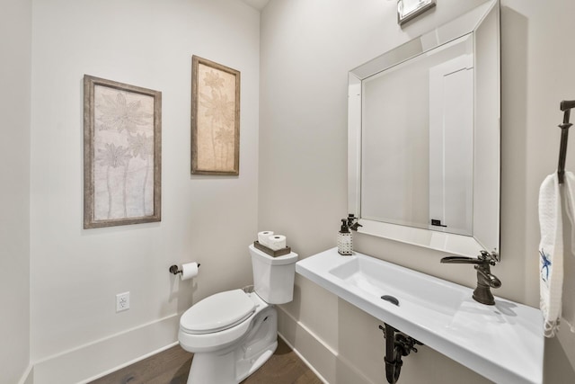 bathroom featuring hardwood / wood-style floors and toilet