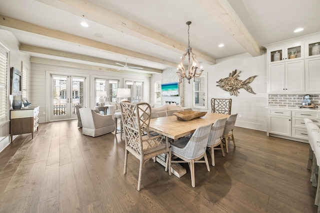 dining room with beamed ceiling, a notable chandelier, and dark hardwood / wood-style flooring