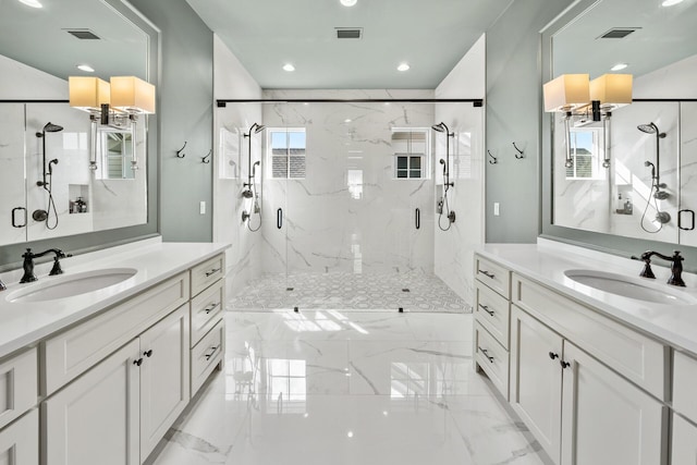 bathroom featuring vanity and a shower with door