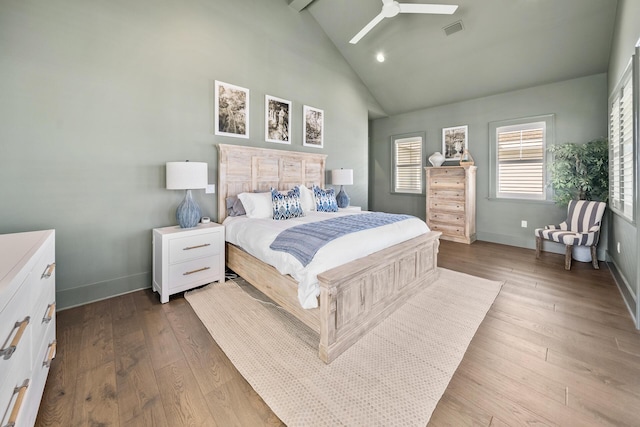 bedroom with beam ceiling, high vaulted ceiling, ceiling fan, and light wood-type flooring