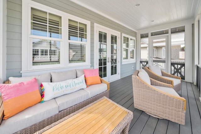 sunroom / solarium featuring wooden ceiling and french doors