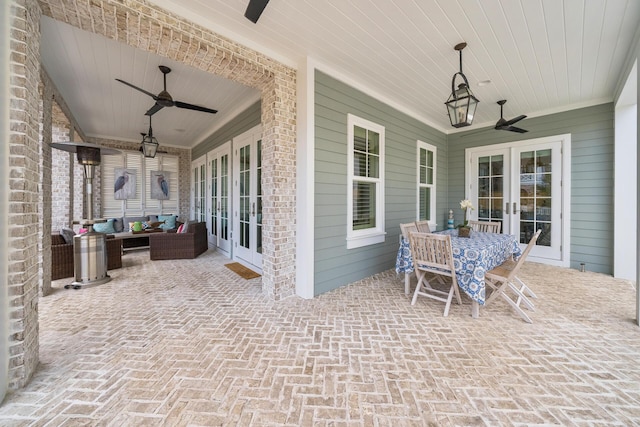 view of patio / terrace with an outdoor living space, ceiling fan, and french doors