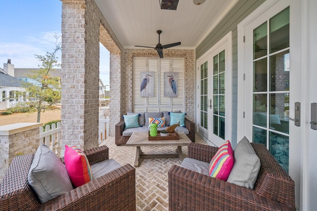 exterior space with ceiling fan and an outdoor living space