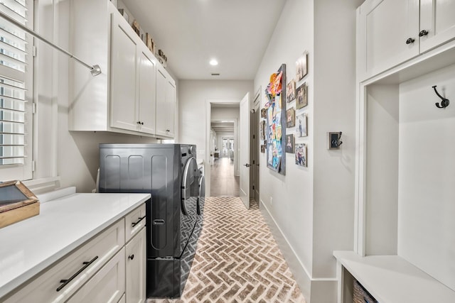 laundry area featuring cabinets and washing machine and clothes dryer