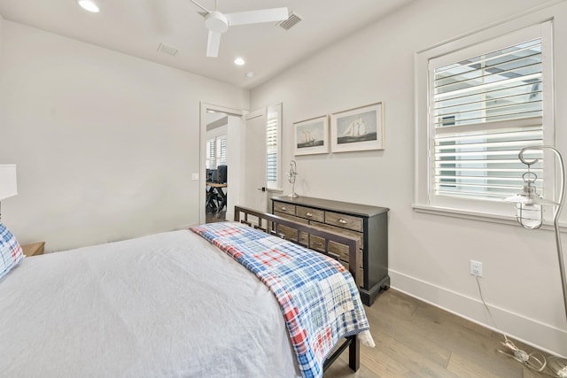 bedroom with ceiling fan and hardwood / wood-style floors