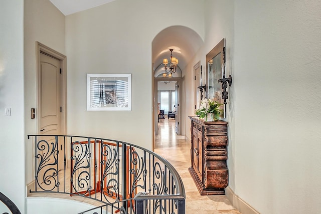 hallway featuring a notable chandelier