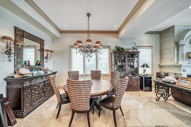 dining space featuring crown molding, plenty of natural light, and a chandelier